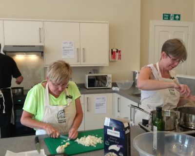 people cooking in community food hub