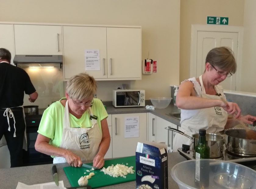 people cooking in community food hub