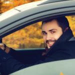 man driving car