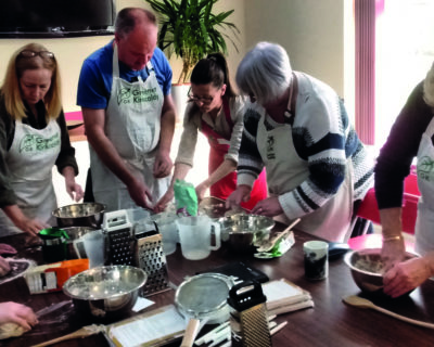 people cooking together in kitchen
