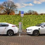 two electric cars at charging points