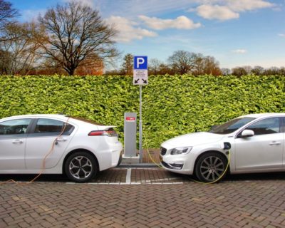 two electric cars at charging points