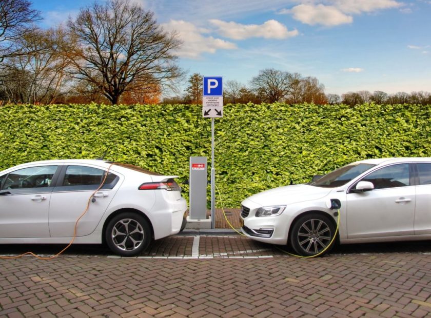 two electric cars at charging points