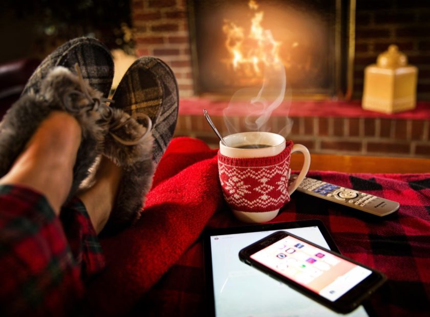 person with slippers on near a fire