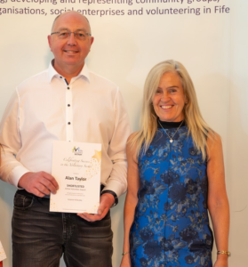 a photo of Alan Taylor standing with Greener Kirkcaldy Volunteer Coordinator, Caroline Morrison